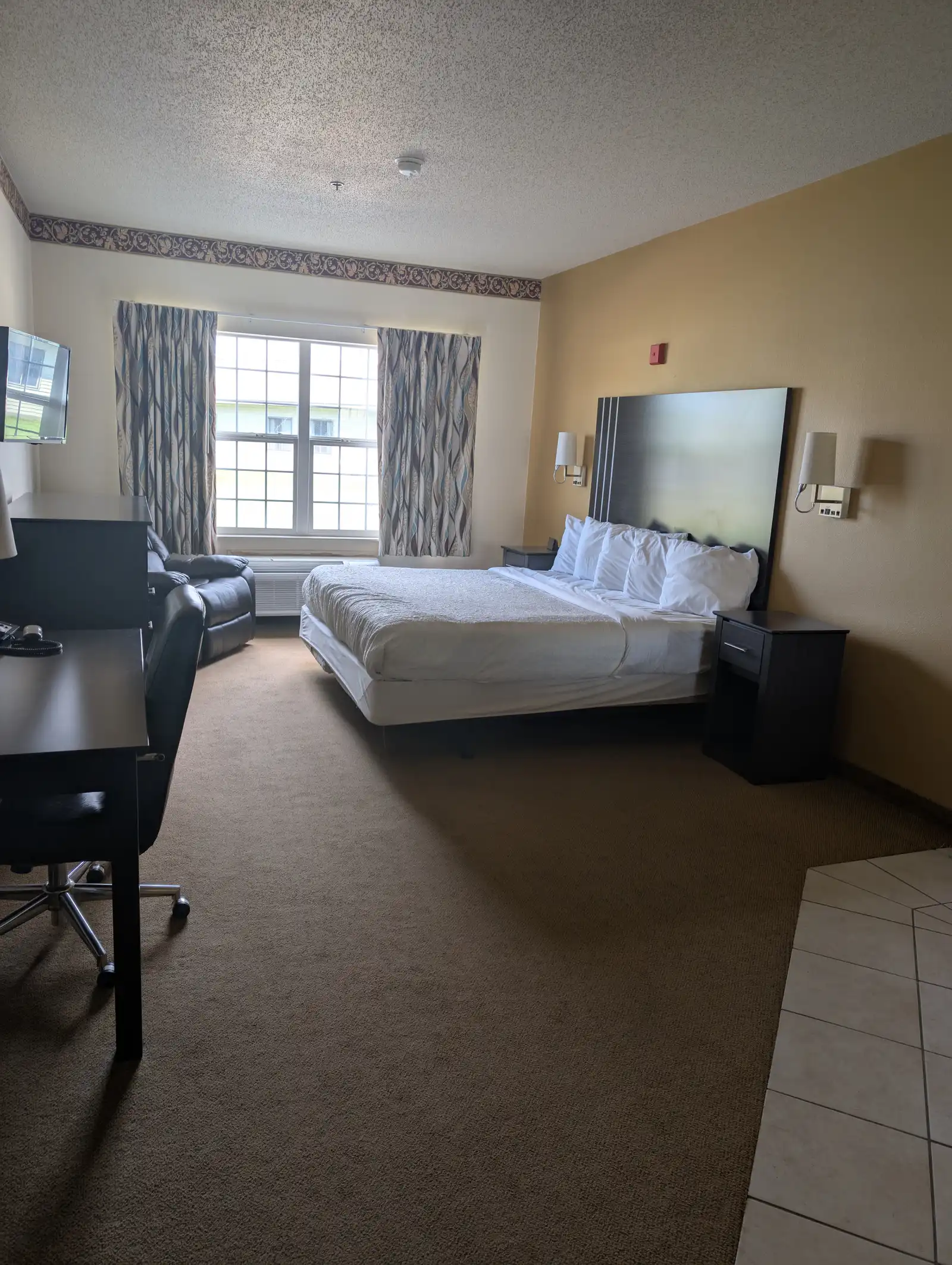A King Whirlpool Suite with a king bed, desk and seating